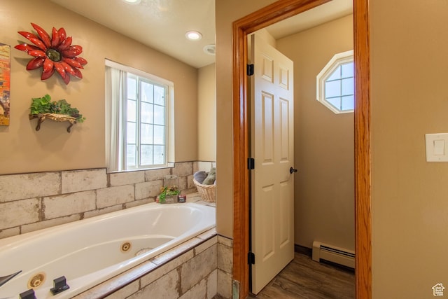 560 N 400 W, Smithfield, UT 84335 - bathroom featuring a baseboard radiator, wood finished floors, a wealth of natural light, and a tub with jets