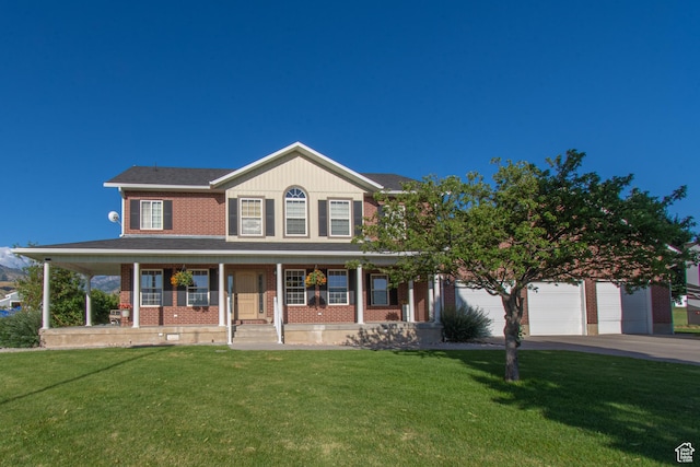 560 N 400 W, Smithfield, UT 84335 - view of front of home with driveway, covered porch, brick siding, a garage, and a front yard