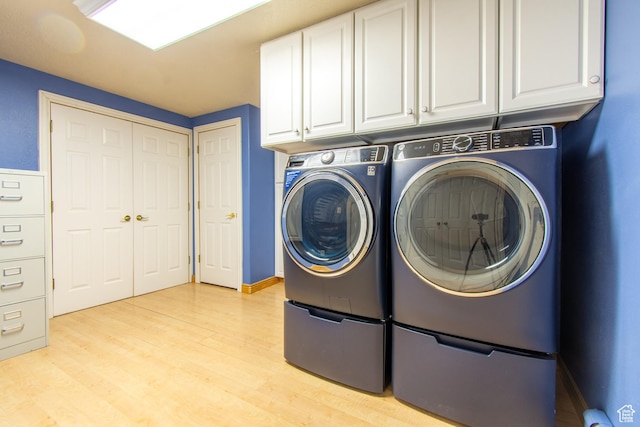 560 N 400 W, Smithfield, UT 84335 - clothes washing area featuring separate washer and dryer, cabinet space, and light wood-style flooring