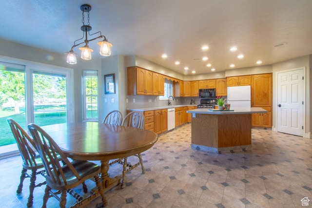 560 N 400 W, Smithfield, UT 84335 - kitchen featuring a center island, a sink, recessed lighting, white appliances, and hanging light fixtures