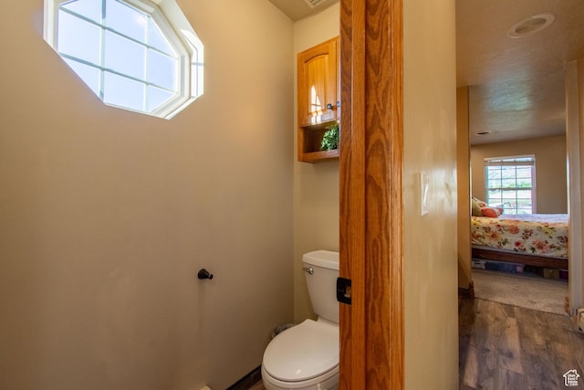 560 N 400 W, Smithfield, UT 84335 - bathroom featuring wood finished floors, ensuite bath, and toilet
