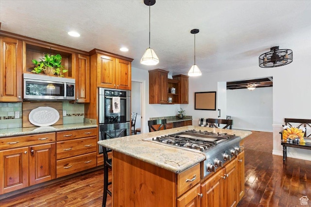 kitchen featuring a breakfast bar, a kitchen island, dark hardwood / wood-style flooring, and stainless steel appliances