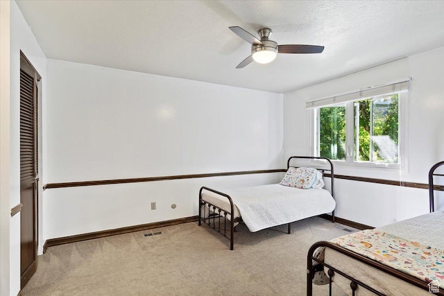 bedroom featuring ceiling fan and light colored carpet
