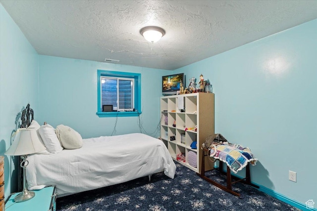 carpeted bedroom with a textured ceiling