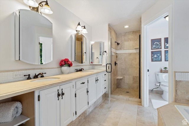 bathroom featuring vanity, a shower with door, tile patterned floors, decorative backsplash, and toilet