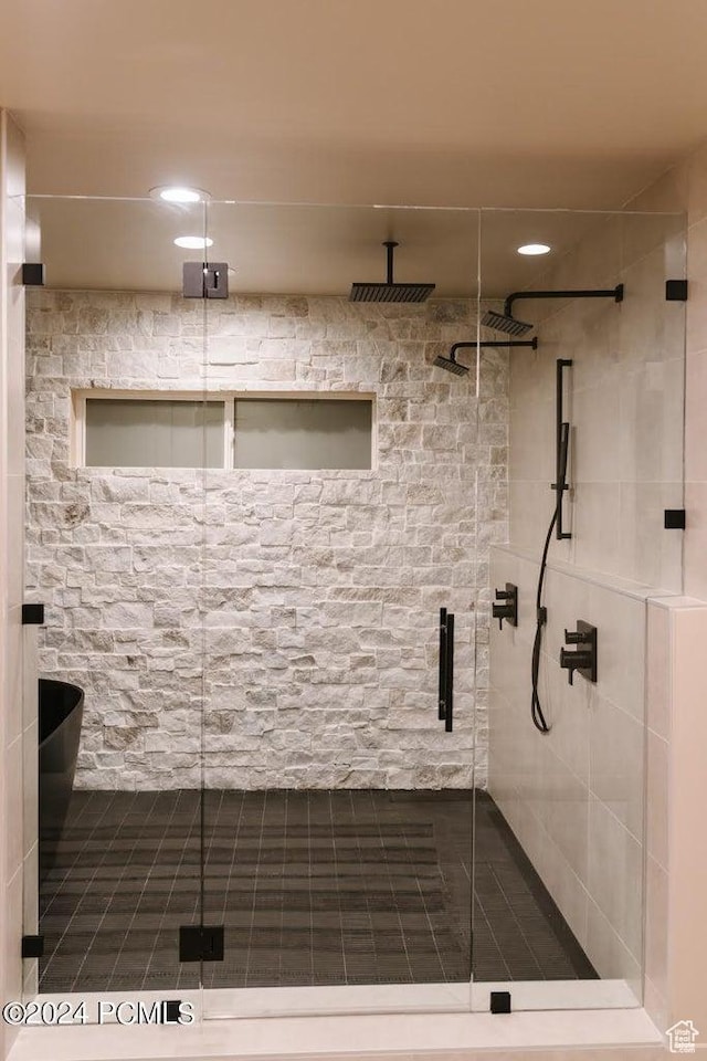 bathroom featuring a shower with shower door
