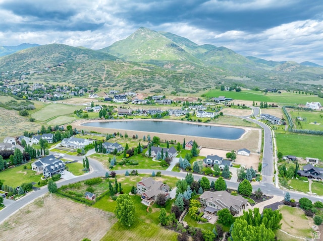 birds eye view of property featuring a water and mountain view
