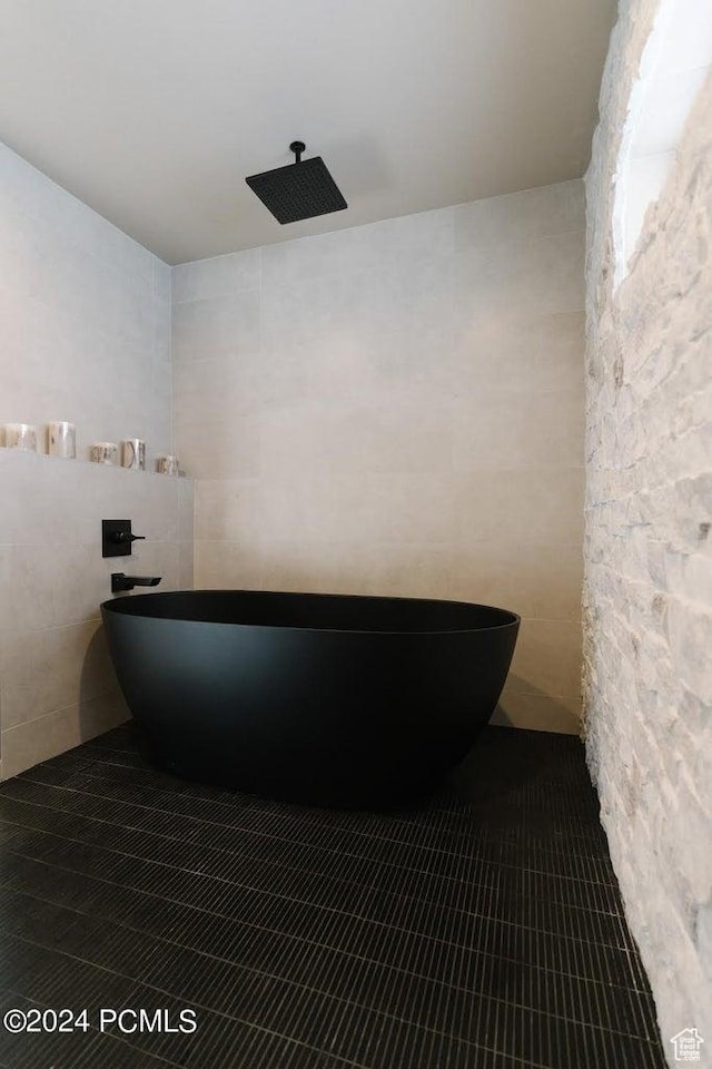 bathroom featuring tile patterned floors and tile walls