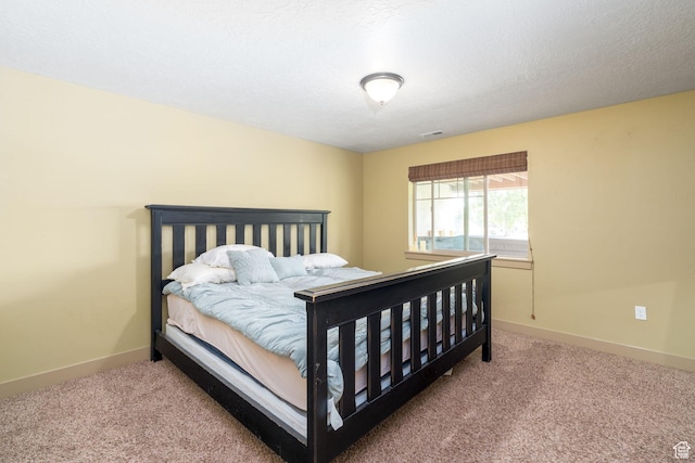 carpeted bedroom featuring a textured ceiling