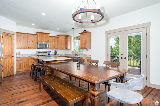 dining room featuring sink, plenty of natural light, dark hardwood / wood-style floors, and french doors