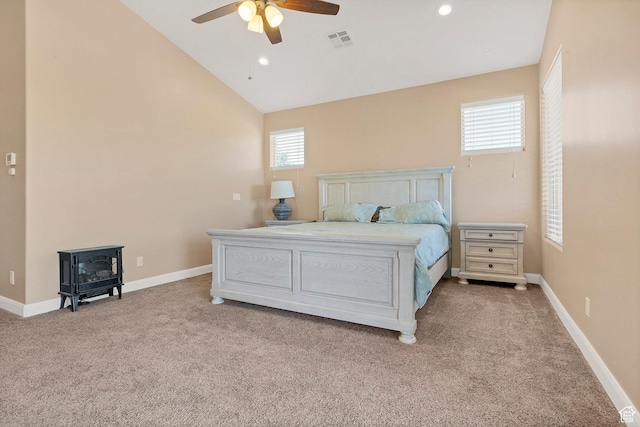 1536 S Cliff Dr, Apple Valley, UT 84737 - bedroom featuring ceiling fan, light carpet, vaulted ceiling, and a wood stove