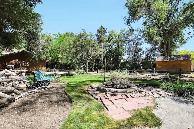 11996 S 3600 W, Riverton, UT 84065 - view of yard featuring an outdoor structure and a fire pit