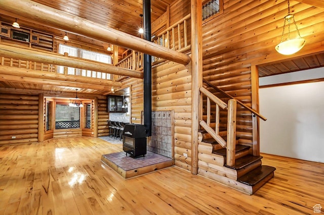11996 S 3600 W, Riverton, UT 84065 - unfurnished living room with a towering ceiling, wood ceiling, hardwood / wood-style floors, a wood stove, and stairs