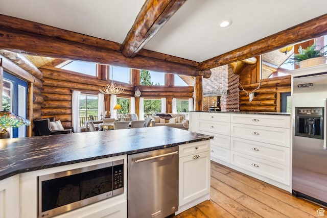 6690 N State Road 32, Peoa, UT 84061 - kitchen with beamed ceiling, light wood-style flooring, dark countertops, appliances with stainless steel finishes, and white cabinets