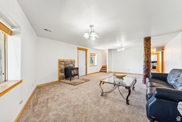 6690 N State Road 32, Peoa, UT 84061 - living area with visible vents, baseboards, carpet floors, a wood stove, and an inviting chandelier