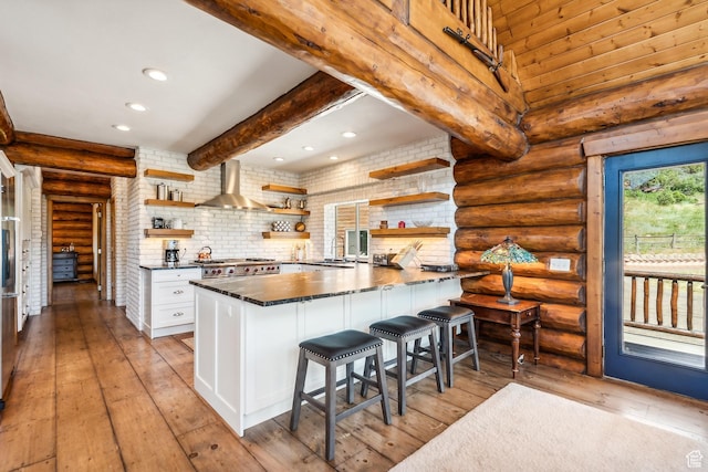 6690 N State Road 32, Peoa, UT 84061 - kitchen with beamed ceiling, recessed lighting, stove, wall chimney exhaust hood, and open shelves