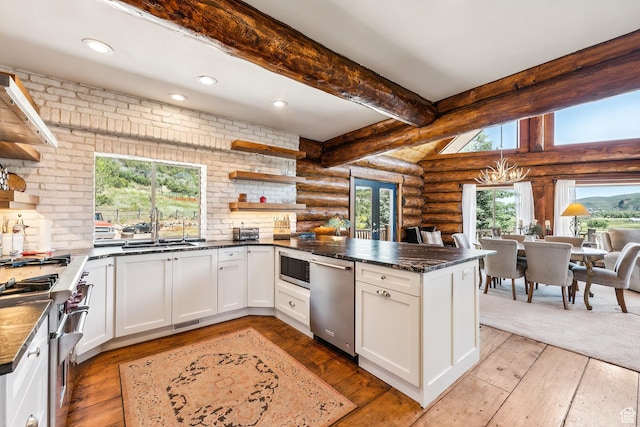 6690 N State Road 32, Peoa, UT 84061 - kitchen featuring beamed ceiling, log walls, a peninsula, stainless steel appliances, and open shelves