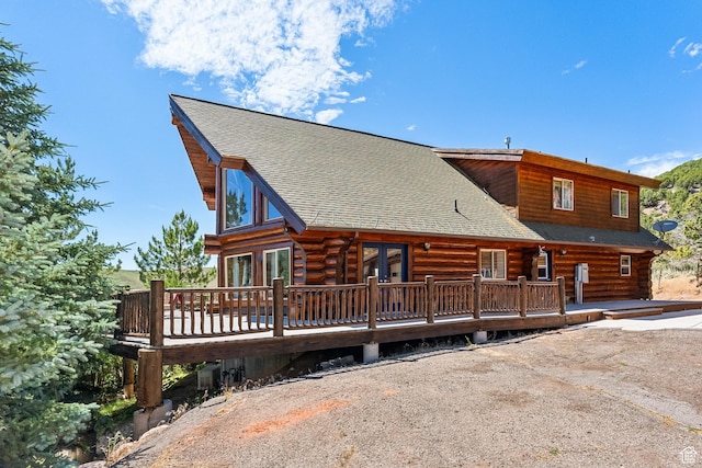 6690 N State Road 32, Peoa, UT 84061 - back of property with log siding, a wooden deck, and a shingled roof
