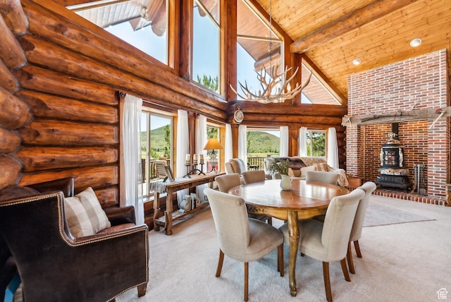 6690 N State Road 32, Peoa, UT 84061 - dining room with beamed ceiling, light carpet, wood ceiling, and a wood stove