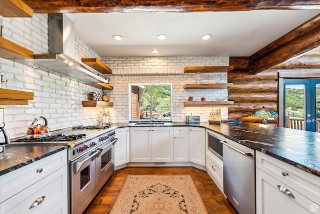 6690 N State Road 32, Peoa, UT 84061 - kitchen featuring open shelves, wall chimney exhaust hood, a healthy amount of sunlight, and appliances with stainless steel finishes