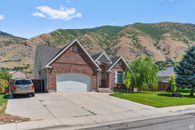 view of front of property featuring a front yard, an attached garage, fence, and brick siding