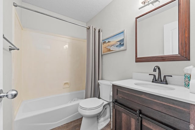 bathroom featuring toilet, vanity, shower / tub combo, wood finished floors, and a textured ceiling