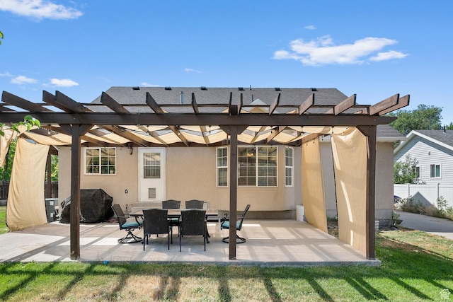 back of property with fence, a patio area, a pergola, and stucco siding