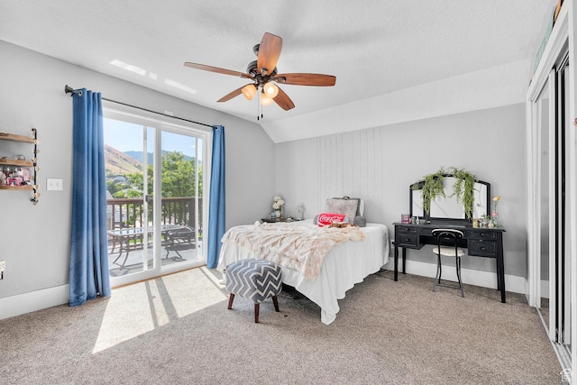 bedroom featuring access to exterior, ceiling fan, vaulted ceiling, carpet floors, and a textured ceiling