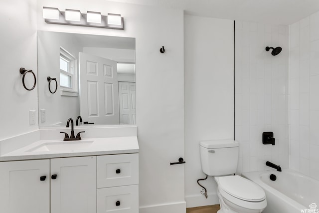 full bathroom with vanity, tiled shower / bath, and toilet