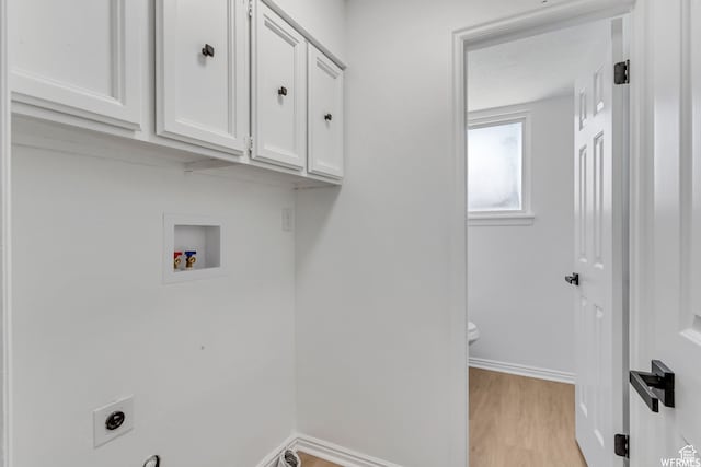 laundry area featuring cabinets, hookup for a washing machine, hookup for an electric dryer, and light wood-type flooring