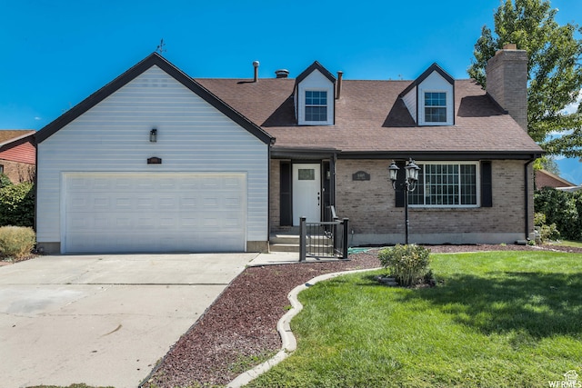 new england style home with a garage and a front lawn