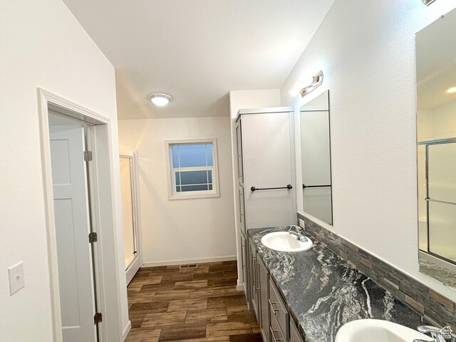 944 E Kiva Dr, Blanding, UT 84511 - full bath featuring double vanity, wood finished floors, a stall shower, and a sink