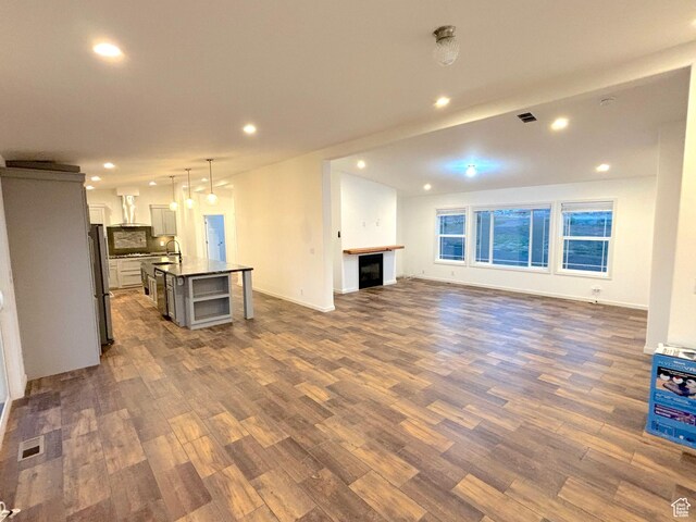944 E Kiva Dr, Blanding, UT 84511 - unfurnished living room with visible vents, a sink, dark wood-style floors, and recessed lighting