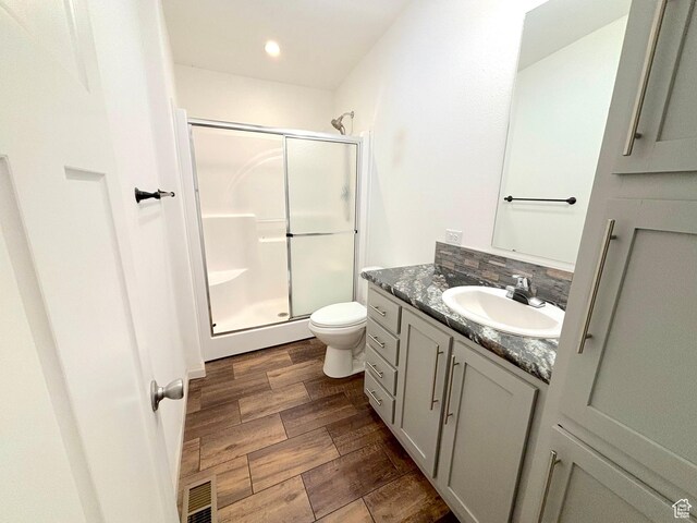 944 E Kiva Dr, Blanding, UT 84511 - bathroom with a stall shower, vanity, toilet, and wood finished floors