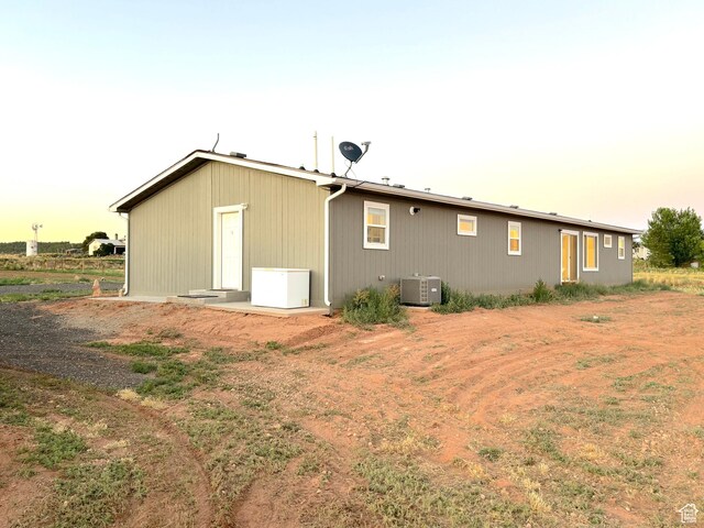 944 E Kiva Dr, Blanding, UT 84511 - back of house at dusk with central AC unit