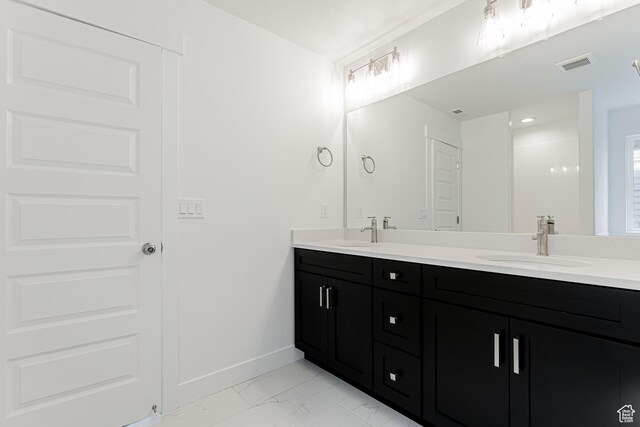 3772 W 1200 N Unit 135, Lehi, UT 84043 - bathroom with double vanity, marble look tiles, and baseboards