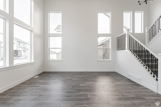 unfurnished living room featuring dark wood-type flooring