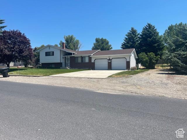split level home with driveway and a garage