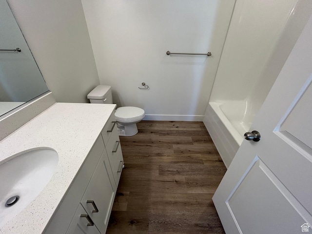 full bathroom with vanity, hardwood / wood-style flooring, independent shower and bath, and toilet