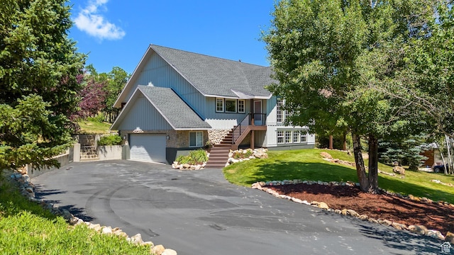9065 Meadow Dr, Sundance, UT 84604 - view of front of property featuring stairs, a front yard, roof with shingles, a garage, and driveway
