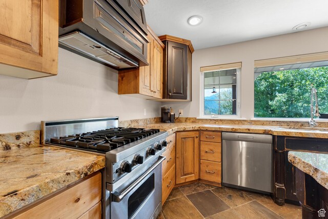 9065 Meadow Dr, Sundance, UT 84604 - kitchen featuring a sink, light stone counters, stone finish flooring, stainless steel appliances, and exhaust hood