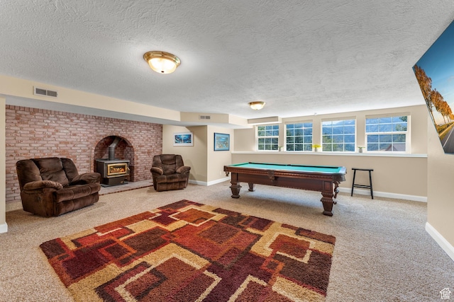 9065 Meadow Dr, Sundance, UT 84604 - rec room with visible vents, carpet floors, and a wood stove