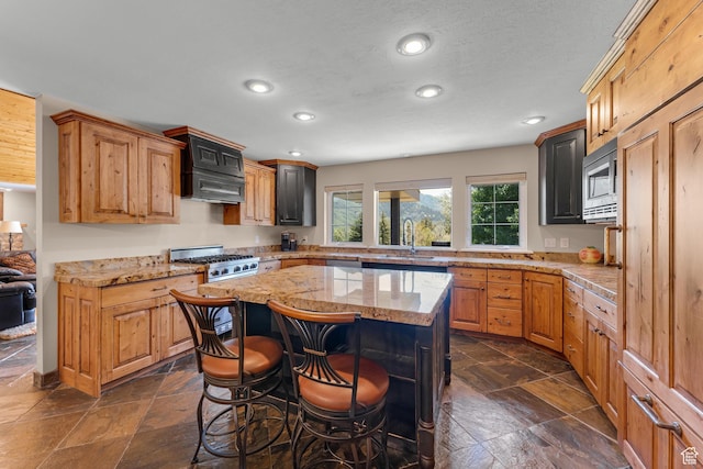 9065 Meadow Dr, Sundance, UT 84604 - kitchen featuring stone tile flooring, a center island, recessed lighting, and stainless steel appliances