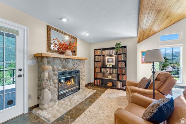 9065 Meadow Dr, Sundance, UT 84604 - living room featuring baseboards, vaulted ceiling, stone tile floors, a stone fireplace, and wooden ceiling