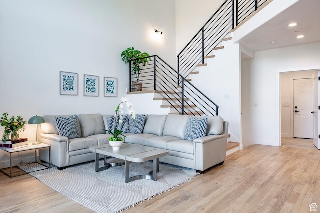 8389 N Pointe Dr, Park City, UT 84098 - living area featuring baseboards, stairs, a towering ceiling, and wood finished floors