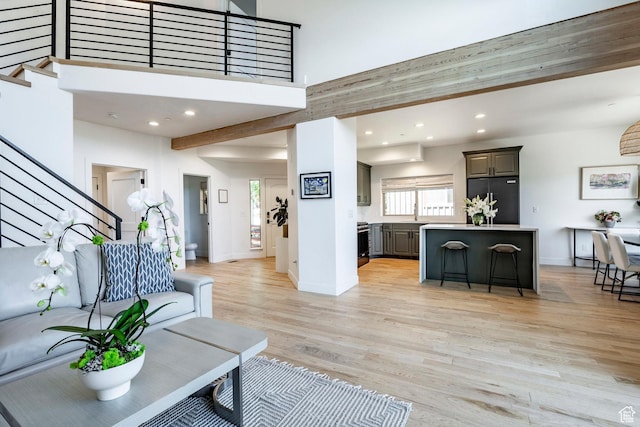 8389 N Pointe Dr, Park City, UT 84098 - living area with baseboards, a towering ceiling, recessed lighting, stairway, and light wood-style floors