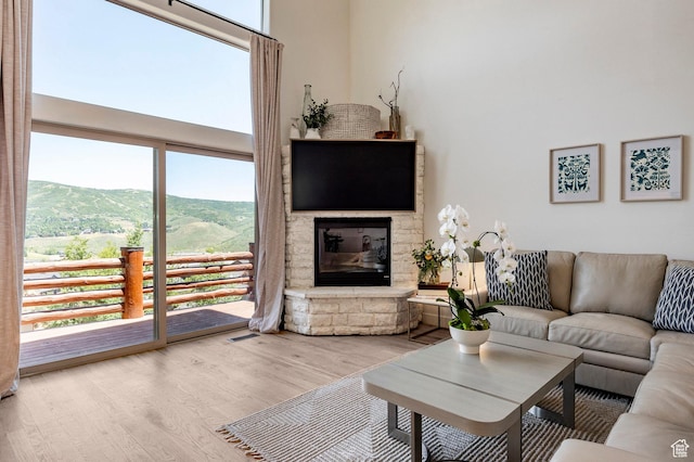 8389 N Pointe Dr, Park City, UT 84098 - living room with visible vents, a mountain view, a fireplace, and wood finished floors