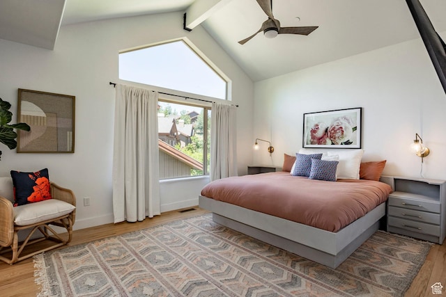 8389 N Pointe Dr, Park City, UT 84098 - bedroom with high vaulted ceiling, beam ceiling, a ceiling fan, light wood-style flooring, and baseboards