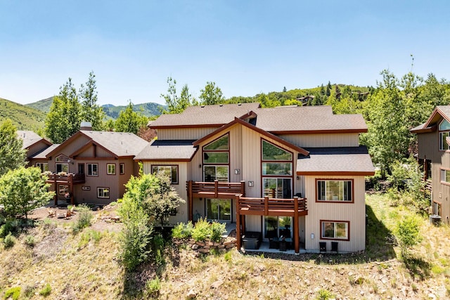 8389 N Pointe Dr, Park City, UT 84098 - rear view of house with a chimney, a shingled roof, and a mountain view