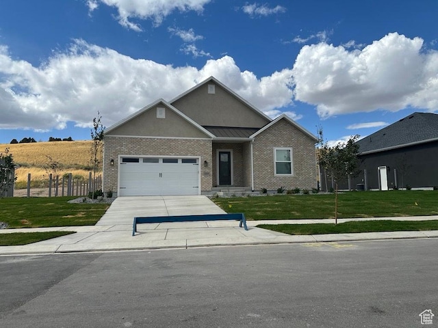 view of front of property with a front yard, driveway, brick siding, and a garage